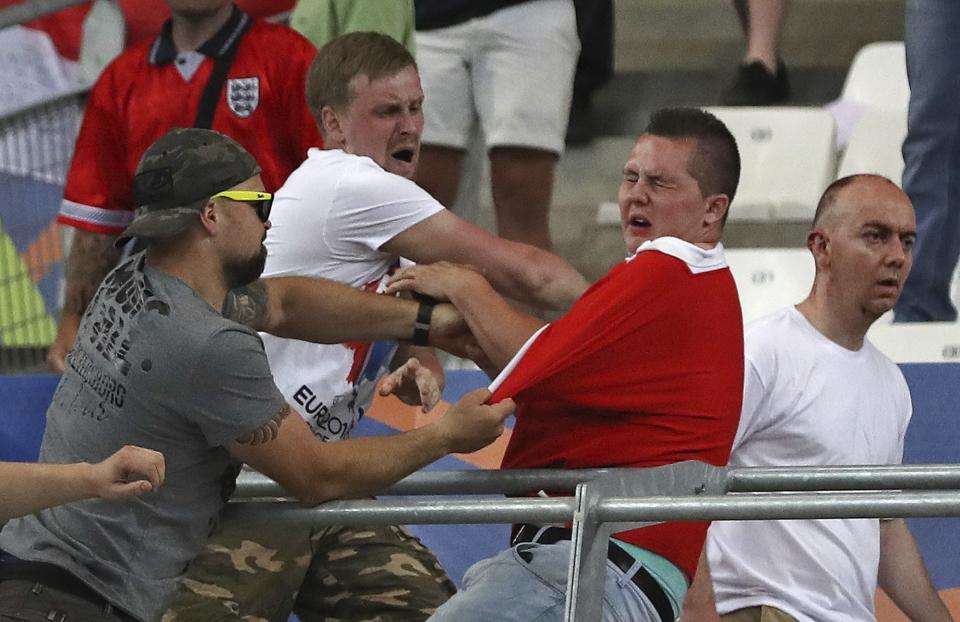 FILE - In this Saturday, June 11, 2016 file photo Russian supporters attack an England fan at the end of the Euro 2016 Group B soccer match between England and Russia, at the Velodrome stadium in Marseille, France. A Russian lawmaker has proposed an unorthodox solution to the country’s football hooliganism woes ahead of next year’s World Cup, legalize it and turn it into a spectator sport. (AP Photo/Thanassis Stavrakis, File)