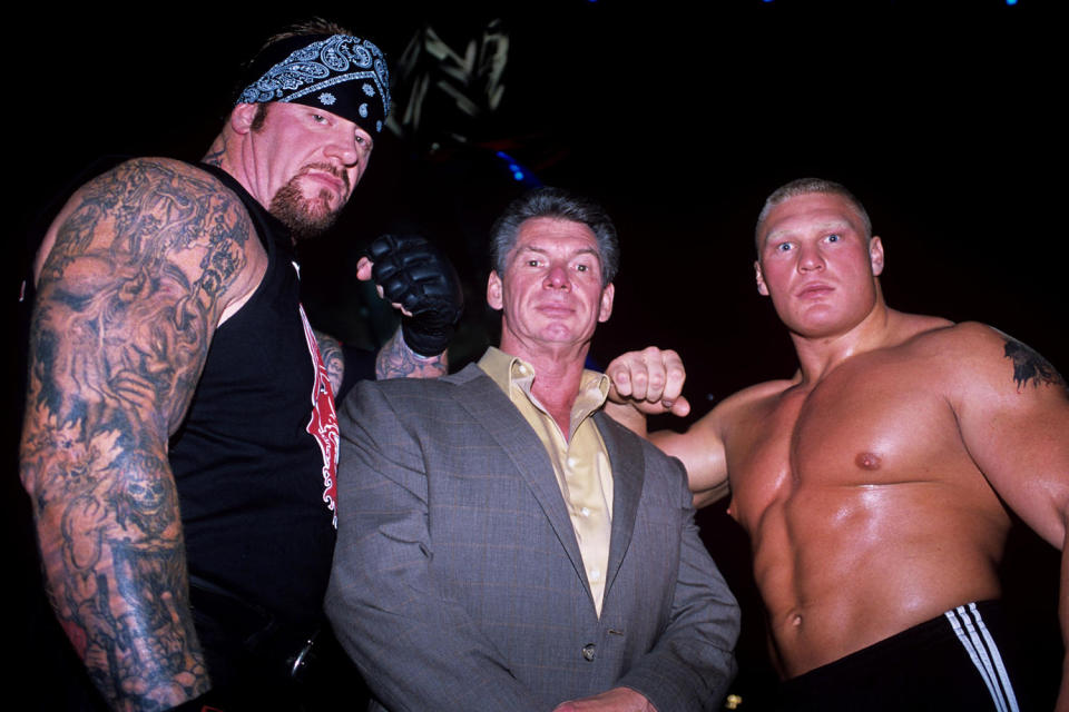 Calaway will be inducted into the WWE Hall of Fame by Vince McMahon (joined in this photo by one of the Undertaker's biggest rivals, Brock Lesnar). (PA Images  via Alamy)