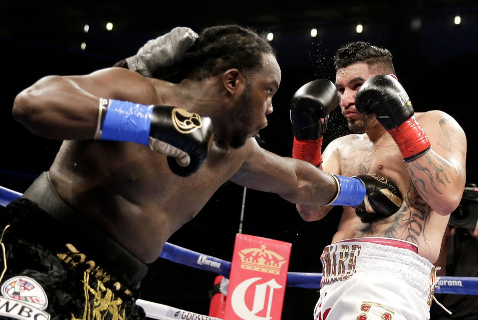Bermane Stiverne, left, hits Chris Arreola during their rematch for the WBC heavyweight boxing title in Los Angeles, Saturday, May 10, 2014. Stiverne won the title. (AP Photo/Chris Carlson)