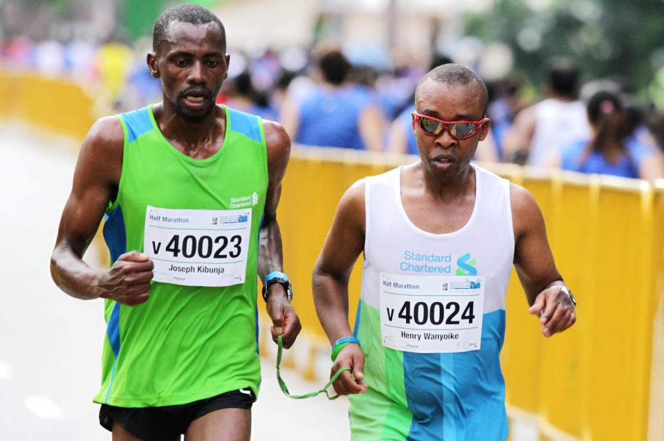 ‘Seeing is Believing’ ambassadors Joseph Kibunja and Henry Wanyoike running the Full Marathon (Photo courtesy of Singapore Sports Council)