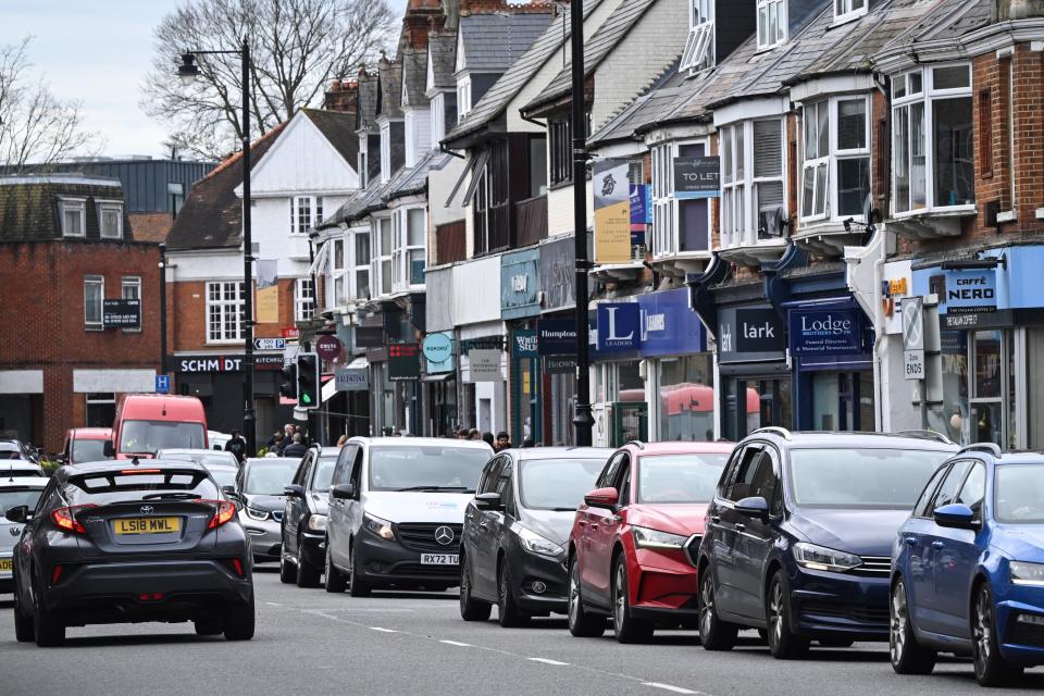 Vehicles queue along the hight street in Weybridge south-west of London on March 16, 2024, as the London orbital motorway M25 sees it's first total closure over a weekend since it's opening in 1986. The M25 will be closed between junctions 10 and 11 from Friday 15 March 2024 evening until Monday 18 March 2024 morning to demolish the Clearmount bridleway bridge and install a very large gantry. (Photo by JUSTIN TALLIS / AFP) (Photo by JUSTIN TALLIS/AFP via Getty Images)