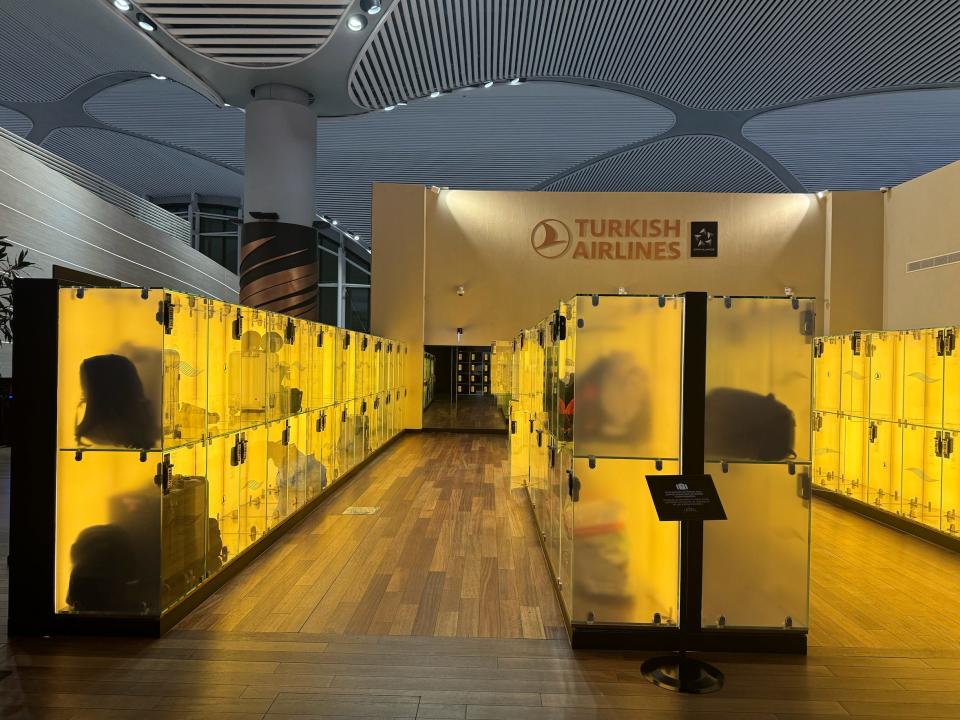 A baggage storage area with translucent yellow lockers.