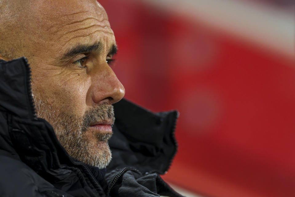 Manchester City's head coach Pep Guardiola looks out from the bench prior the English Premier League soccer match between Brentford and Manchester City at the Gtech Community Stadium in London, Monday, Feb. 5, 2024. (AP Photo/Ian Walton)