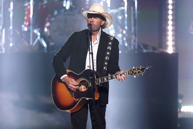 <p>Mickey Bernal/NBC via Getty</p> Toby Keith performs on stage during the 2023 People's Choice Country Awards held at the Grand Ole Opry House in September 2023