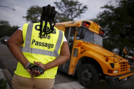 Safe Passage worker Brenda Montgomery stands at an intersection near Sherwood Elementary School in the Englewood neighborhood in Chicago, Illinois, United States, September 8, 2015. REUTERS/Jim Young