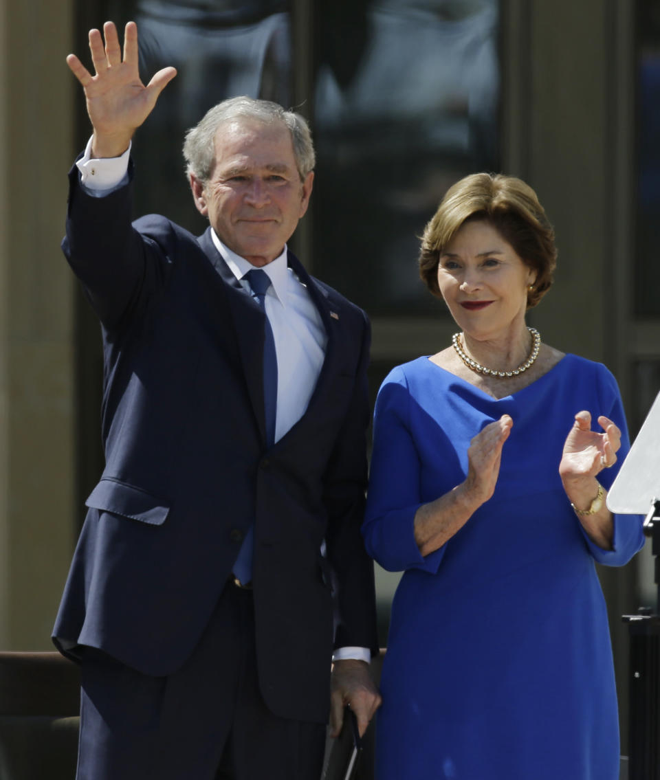 Former president George W. Bush waves with his wife Laura speech during the dedication of the George W. Bush presidential library on Thursday, April 25, 2013, in Dallas. (AP Photo/David J. Phillip)