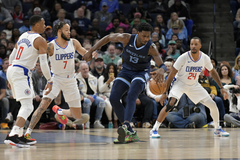 Memphis Grizzlies forward Jaren Jackson Jr. (13) handles the ball between Los Angeles Clippers guards Russell Westbrook (0), Amir Coffey (7) and Norman Powell (24) during the first half of an NBA basketball game Friday, Jan. 12, 2024, in Memphis, Tenn. (AP Photo/Brandon Dill)
