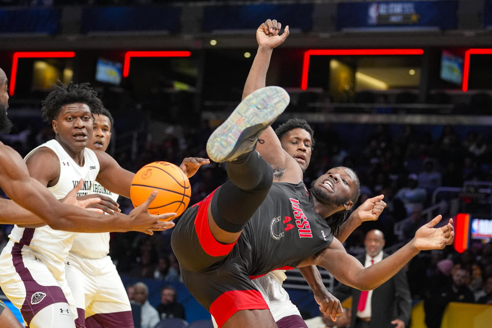 Winston-Salem State forward Imajae Dodd (44) loses the ball after being fouled by Virginia Union forward Joshua Caine, back right, during the second half of the HBCU Classic NCAA college basketball game in Indianapolis, Saturday, Feb. 17, 2024. (AP Photo/Michael Conroy)
