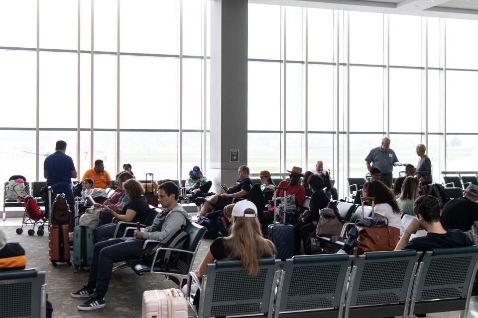 Travelers wait for their flight at McGhee Tyson Airport earlier this week.