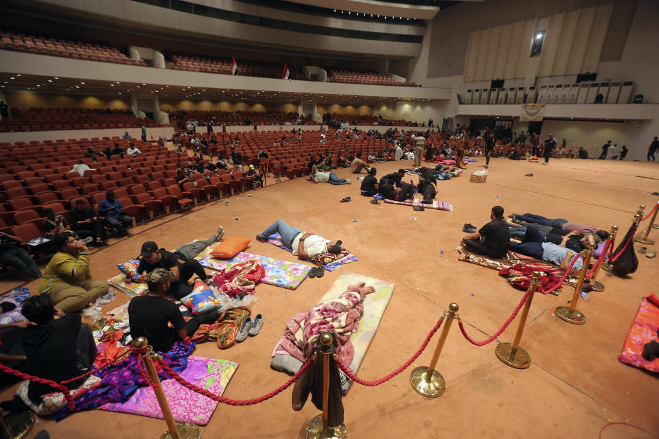 Iraqi protesters rest inside the Parliament building in Baghdad, Iraq, Sunday, July 31, 2022.(AP Photo/Anmar Khalil)