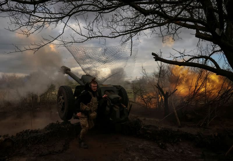 FILE PHOTO: Ukrainian service members fire a howitzer D30 at a front line near the city of Bakhmut