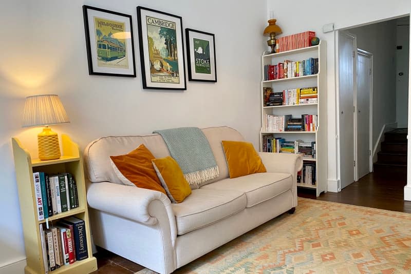 Bookshelves in living room with cream sofa.