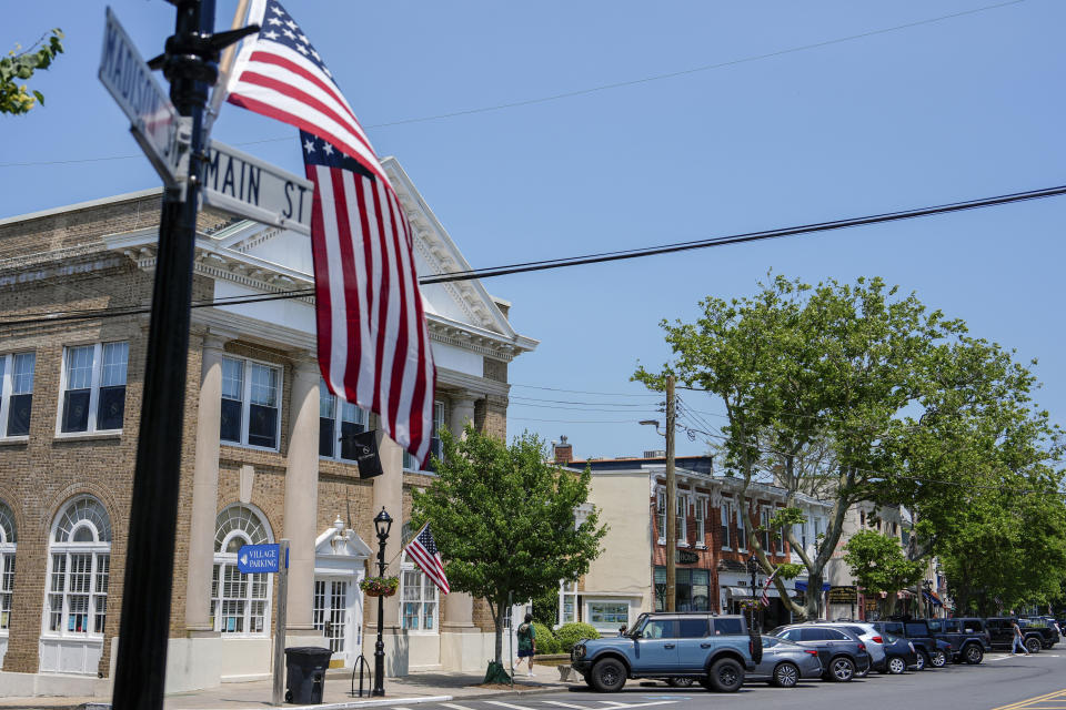 Flags adorn light poles on Main Street in Sag Harbor, N.Y., Tuesday, June 18, 2024. Pop star Justin Timberlake was charged early Tuesday with driving while intoxicated in Sag Harbor after police said he ran a stop sign and veered out of his lane in the posh seaside summer retreat. (AP Photo/Julia Nikhinson)