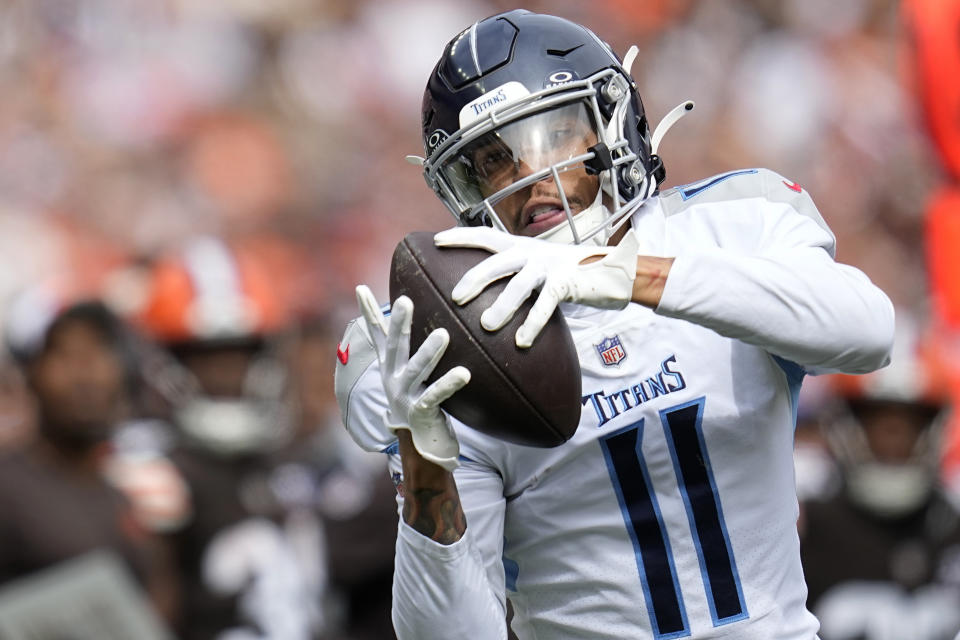 FILE - Tennessee Titans wide receiver Chris Moore (11) makes a catch during the first half of an NFL football game against the Cleveland Browns, Sunday, Sept. 24, 2023, in Cleveland. The intensity of NFL fandom can make players seem simply like avatars on a screen and increase the ever-present pressure to perform. (AP Photo/Sue Ogrocki, File)