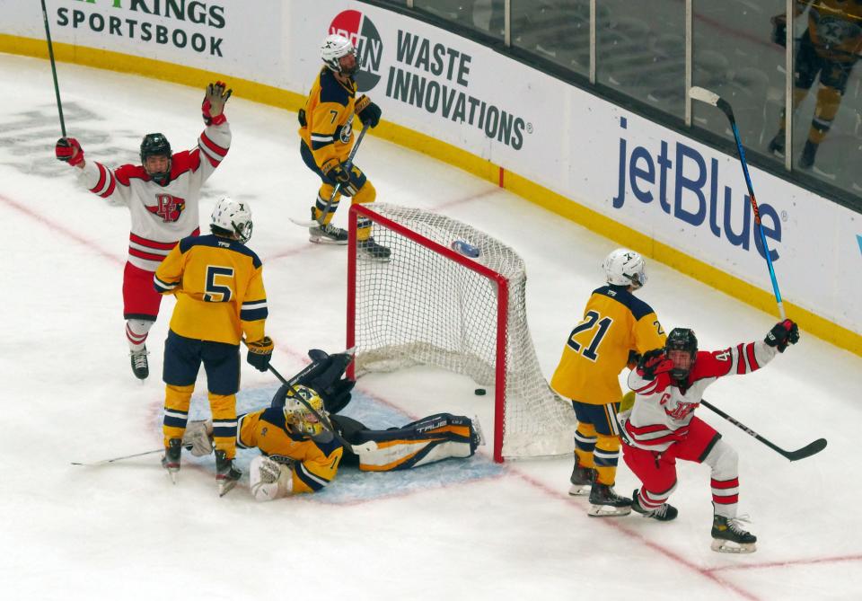 Josh Iby of Pope Francis (lower right) scores the game 3-2 winner to beat Xaverian's goalie Cole Pouliot-Porter with just seconds left in the game on Sunday, March 19, 2023.