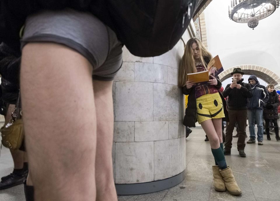 Passengers without their pants wait on a underground platform during the "No Pants Subway Ride" in Kiev