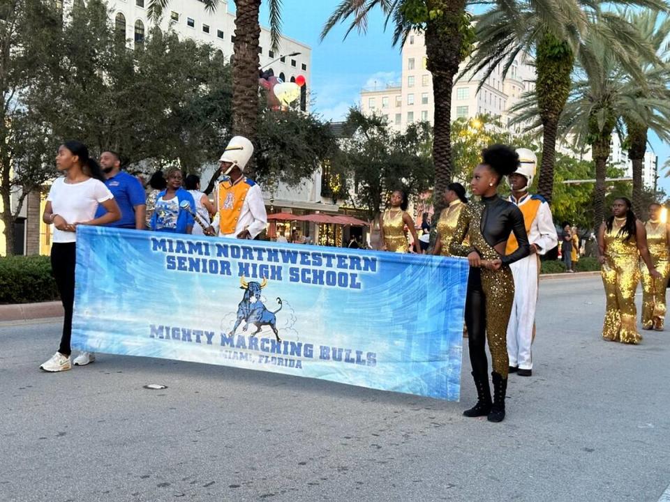 Miami Northwestern Senior High School’s Mighty Marching Bulls brings some Rockettes’-style flair and some musical pizzazz to the 75th Annual Junior Orange Bowl Parade on Miracle Mile in Coral Gables on Dec. 10, 2023.