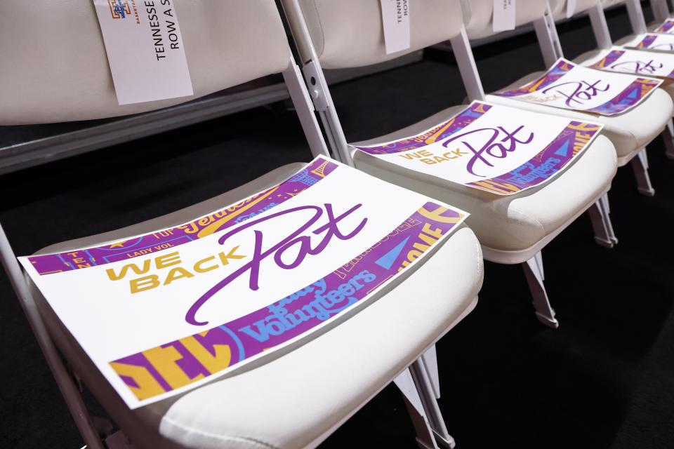 Signs in support of late Tennessee women's head coach Pat Summitt sit in chairs courtside before an NCAA college basketball game between Tennessee and Kentucky, Sunday, Jan. 16, 2022, in Knoxville, Tenn. (AP Photo/Wade Payne)