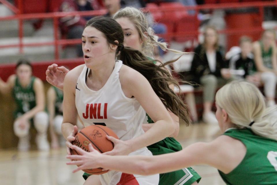 Jim Ned's Lexi Wishert drives between two Wall defenders on Jan. 7.