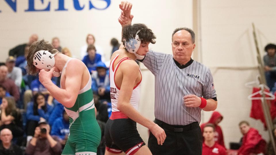 Haddonfield's Michael Lamb has his arm raised after defeating West Deptford's Ryan McConaghy, 10-0, during the 106 lb. bout of the championship round of the District 28 wrestling tournament held at the Rowan College of South Jersey in Deptford on Saturday, February 17, 2024.