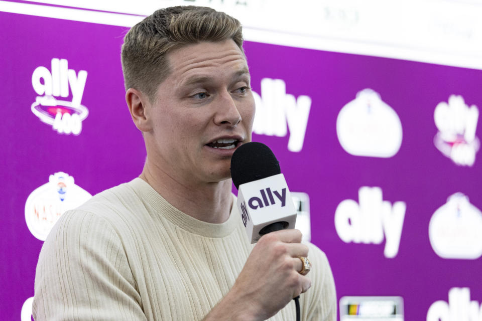 Two-time Indianapolis 500 winner Josef Newgarden speaks to reporters before a NASCAR Cup Series auto race, Sunday, June 30, 2024, in Gladeville, Tenn. (AP Photo/Wade Payne)