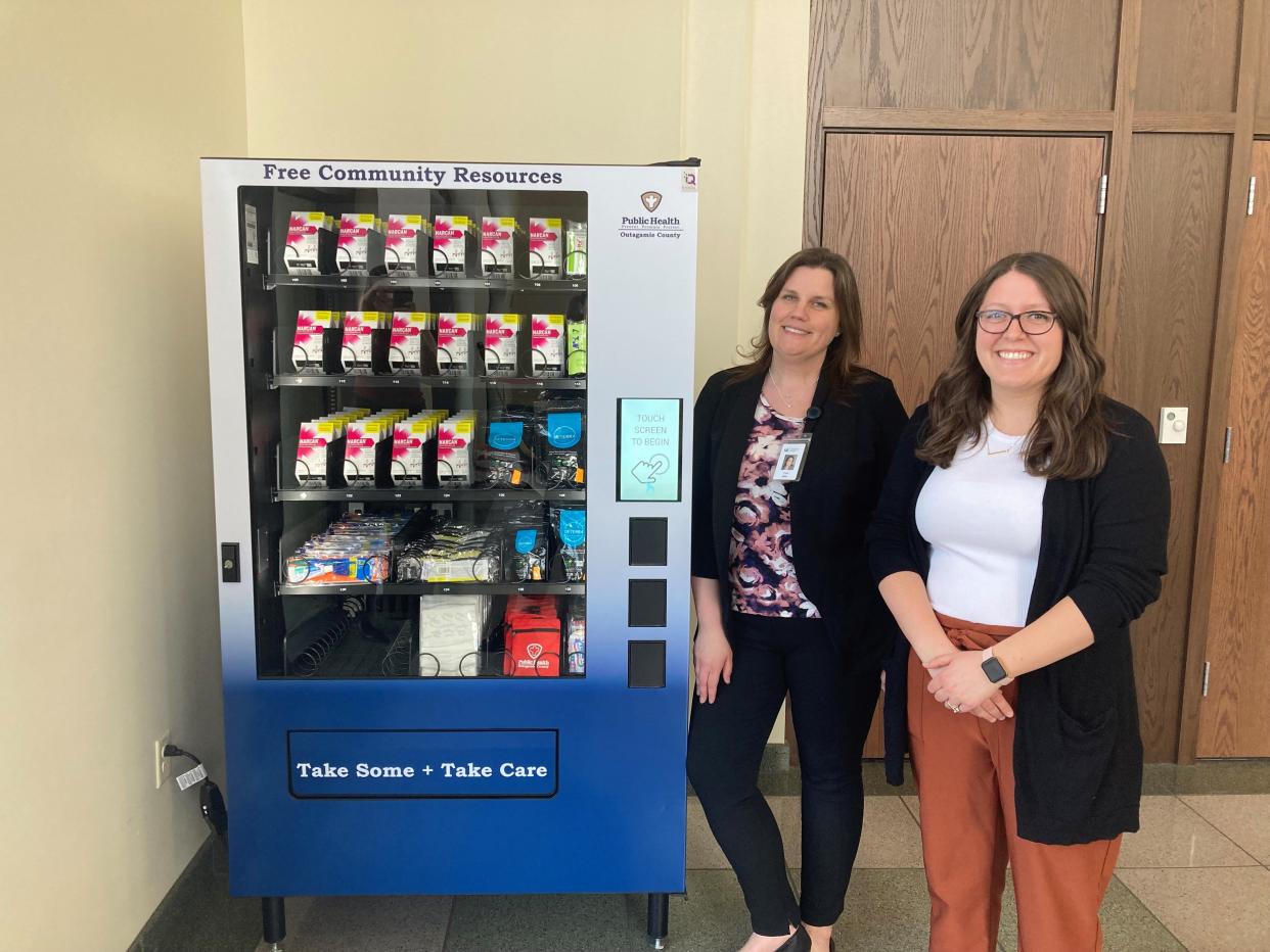 Outagamie County Public Health Division community health educators Carri Ciske and Cassy Stefl help stock the new Public Health Vending Machine at Outagamie County Government Center on Wednesday.