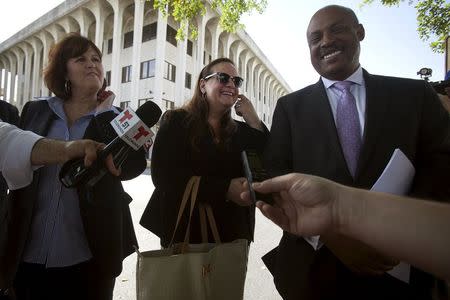 Maria Dominguez (C), a lawyer for Dr. Salomon Melgen (unseen), speaks to the media following a court hearing in West Palm Beach, Florida April 15, 2015. REUTERS/Carlo Allegri