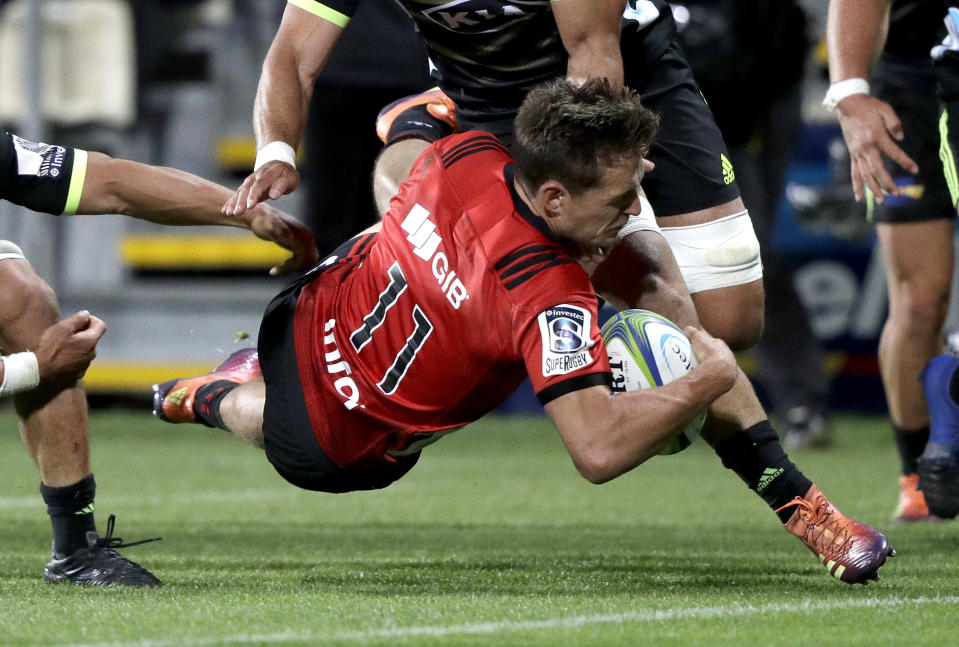 Crusaders George Bridge is airborne as he scores a try during the Super Rugby game between the Crusaders and Hurricanes in Christchurch, New Zealand, Saturday, Feb. 23, 2019. (AP Photo/Mark Baker