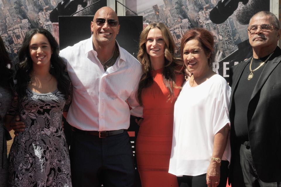 Dwayne Johnson with his family at a film premiere.