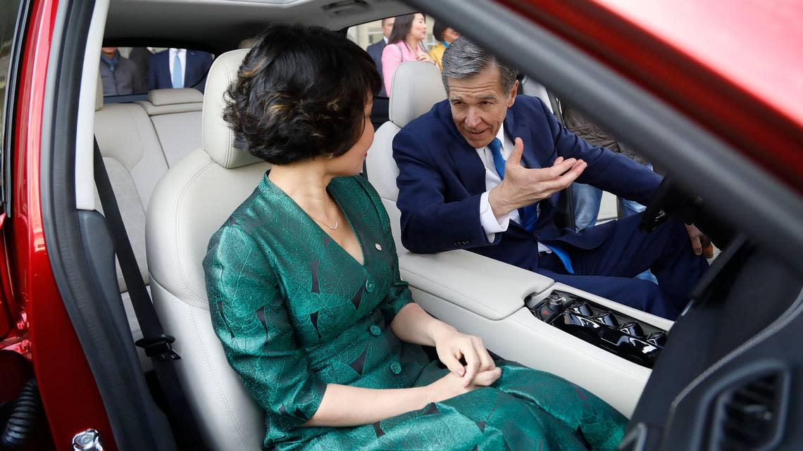 VinFast CEO Le Thi Thu Thuy and N.C. Gov. Roy Cooper sit inside a VF8 electric car Tuesday, March 29, 2022 outside the Raleigh Convention Center.