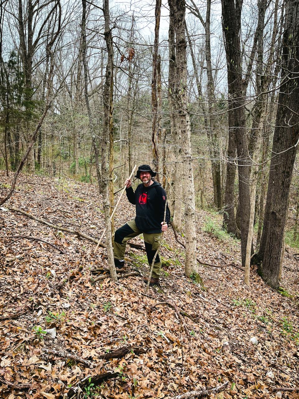 Trent Holloway stands on a hill while mushroom hunting.