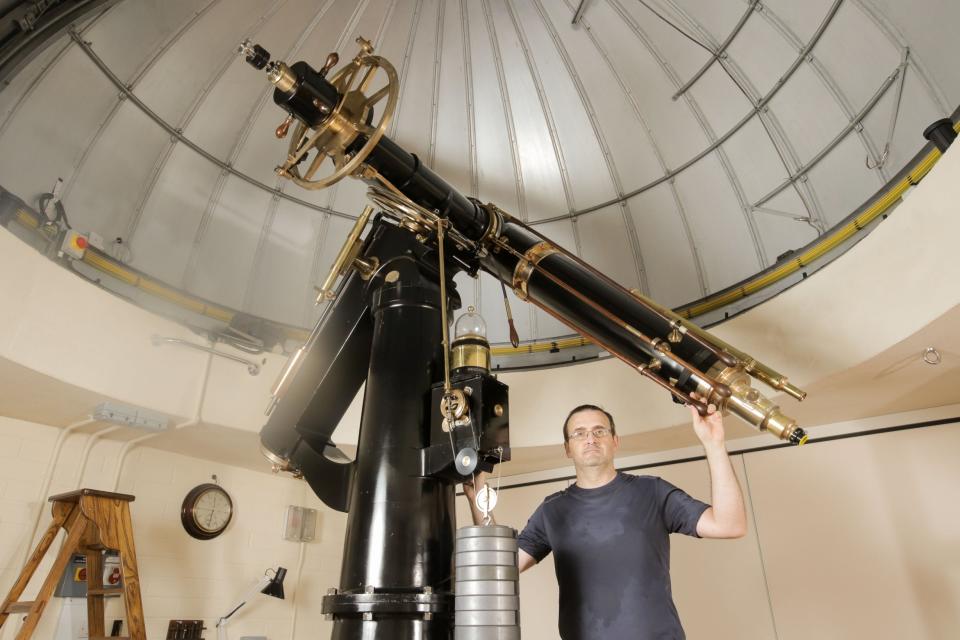 Professor Giorgio Savini with the Fry telescope, which was built in 1862 using brass and bronze components (Matt Writtle)