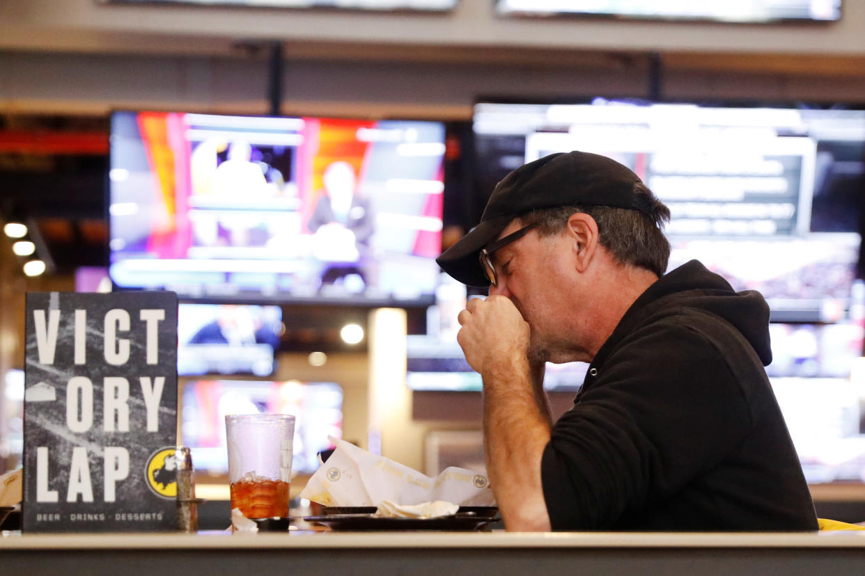 A man eats inside of a Buffalo Wild Wings restaurant in New York, U.S., February 6, 2017.  REUTERS/Lucas Jackson