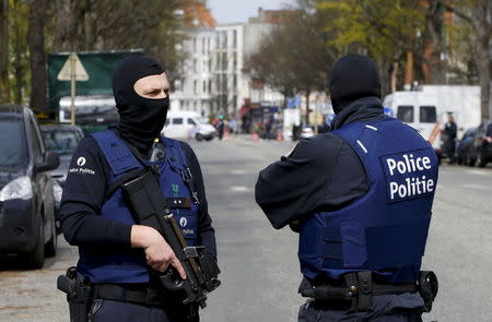 Belgium police officers secure the access during a police operation in Etterbeek, near Brussels, Belgium, April 9, 2016. REUTERS/Yves Herman