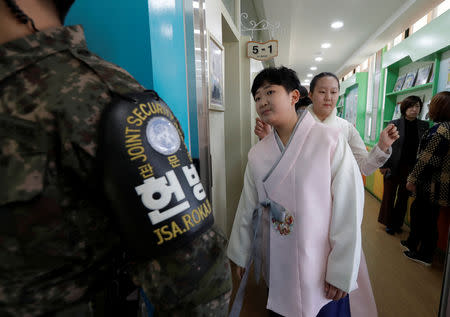 Graduates of elementary school wait to attend at a graduation ceremony at Taesungdong freedom village inside the demilitarized zone between North and South Korea, near the border village of Panmunjom in Paju, South Korea, Friday, Jan. 11, 2019. Lee Jin-man/Pool via REUTERS