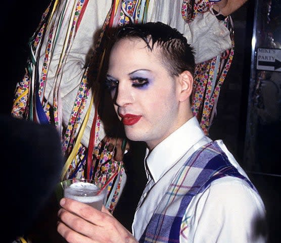 Alig holding a drink while out at a nightclub