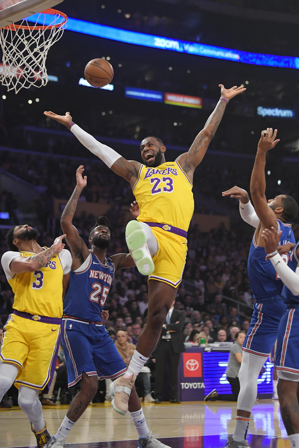 Los Angeles Lakers forward LeBron James (23) has the ball knocked from his hands while trying to shoot by New York Knicks guard Wayne Ellington, right, as forward Anthony Davis, left, and guard Reggie Bullock vie for position during the first half of an NBA basketball game Tuesday, Jan. 7, 2020, in Los Angeles. (AP Photo/Mark J. Terrill)