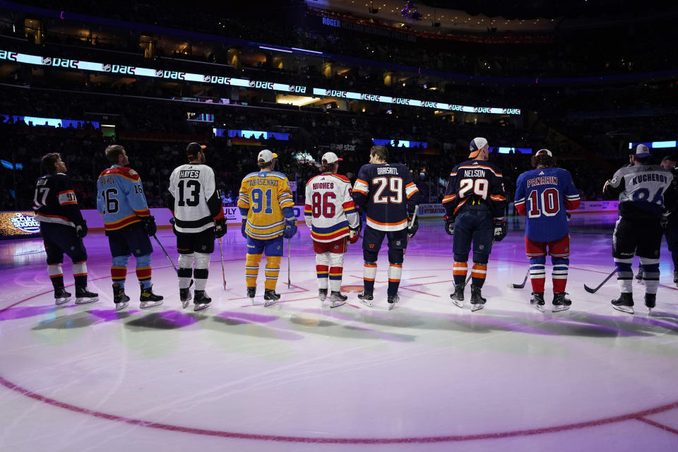 NHL hockey players stand before they are introduced before the NHL All Star Skills Showcase, Friday, Feb. 3, 2023, in Sunrise, Fla. (AP Photo/Lynne Sladky)