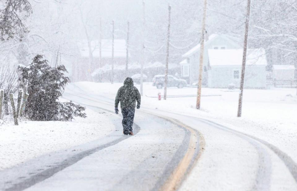 A man walks in North Attleborough, Massachusetts (AP)