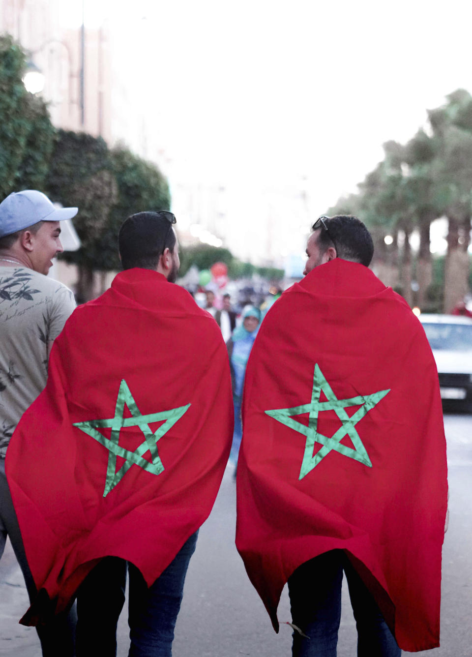 Moroccans celebrate their World Cup victory against Portugal in the Morocco-administered Western Sahara city of Laayoune, Saturday, Dec. 10, 2022. (AP Photo/Noureddine Abakchou)