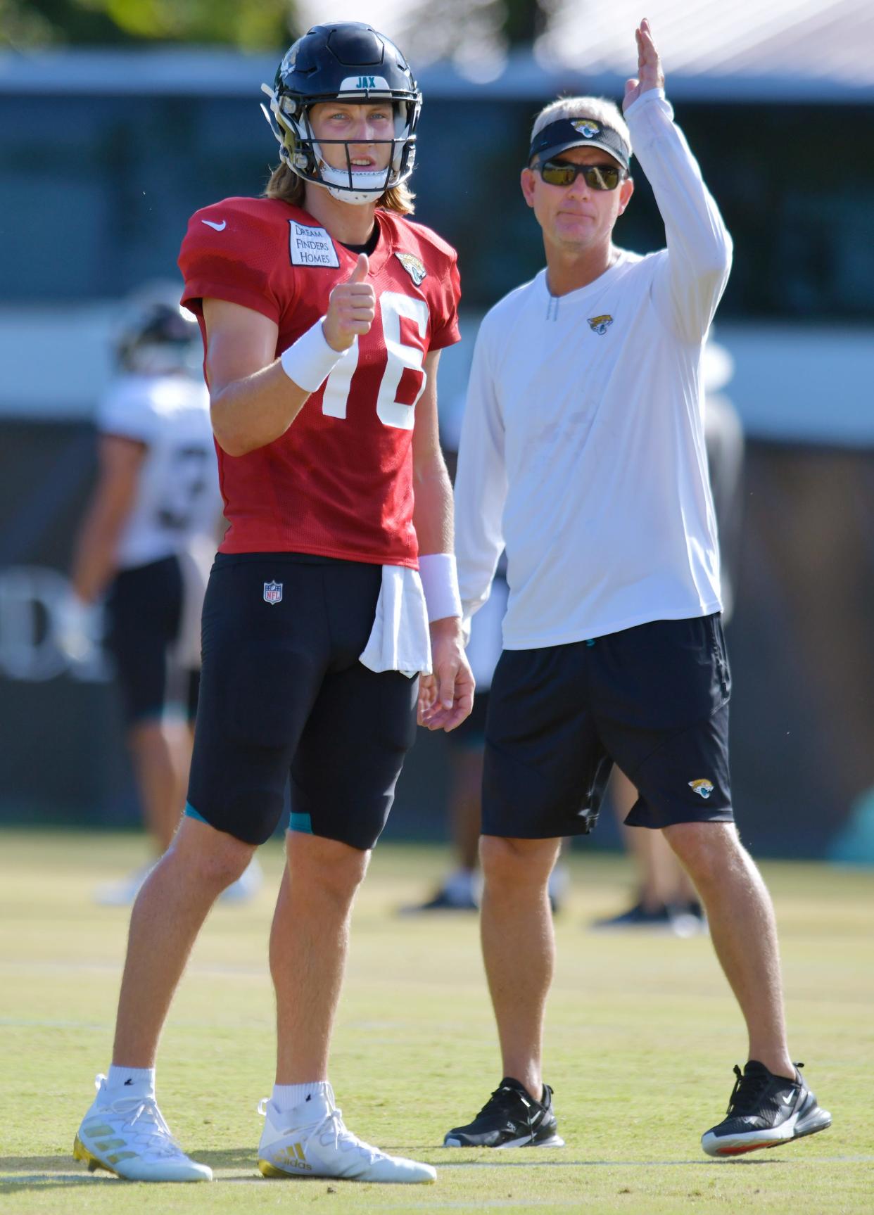 Jacksonville Jaguars quarterback Trevor Lawrence (16) talks with Quarterbacks coach Mike McCoy during Monday's training camp session. The Jacksonville Jaguars held training camp Monday, August 1, 2022, at the Episcopal School of Jacksonville Knight Campus practice fields on Atlantic Blvd.