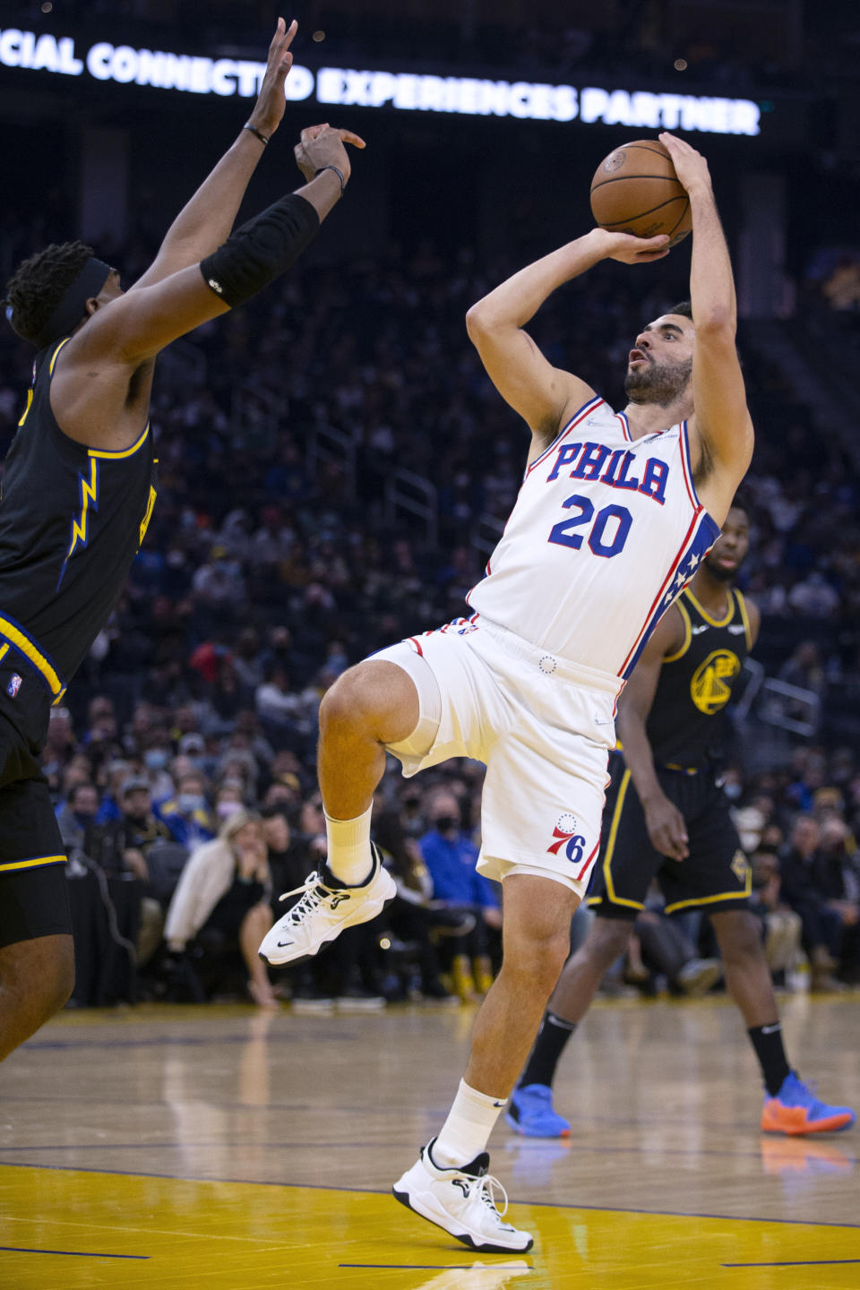 Philadelphia 76ers forward Georges Niang (20) shoots a fadeaway jumper over Golden State Warriors forward Kevon Looney during the first quarter of an NBA basketball game Wednesday, Nov. 24, 2021, in San Francisco. (AP Photo/D. Ross Cameron)