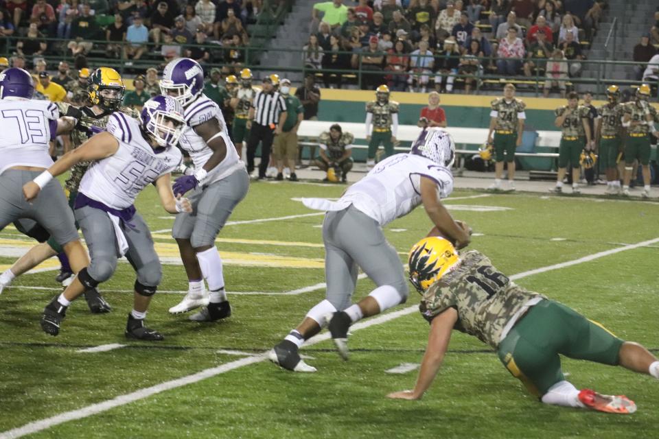 Ross' Kaden Holmes scrambles away from a defender he left on the turf.