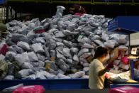 Employees sort parcels at a logistics base on the Singles' Day online shopping festival in Yiwu