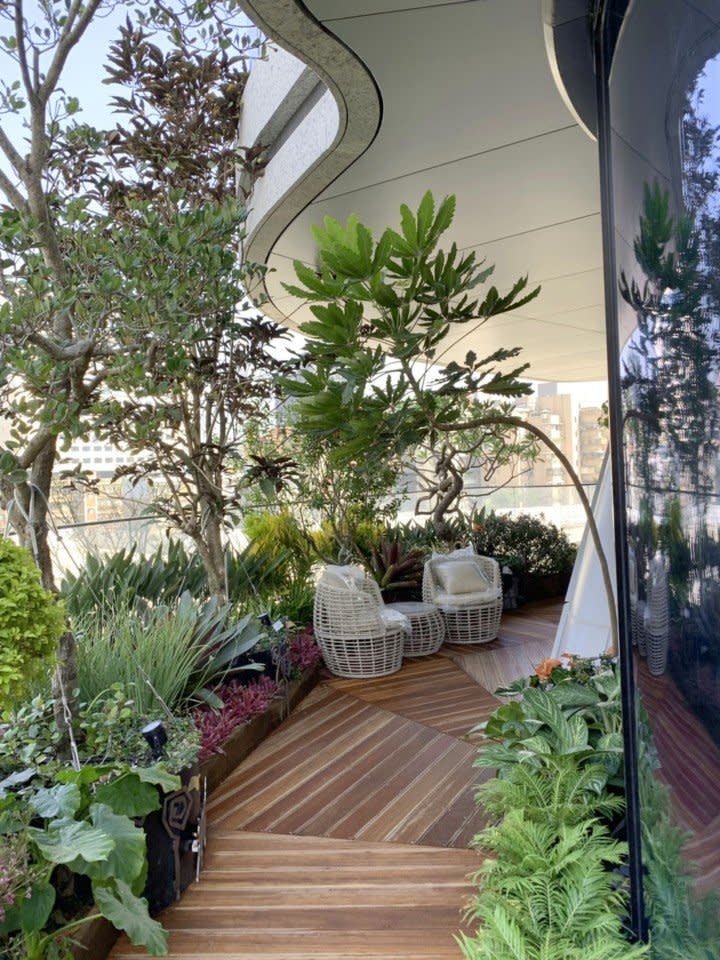 Adorable rattan table and chairs grace a lush green balcony in Taipei's soon-to-be-complete Agora Garden Tower.