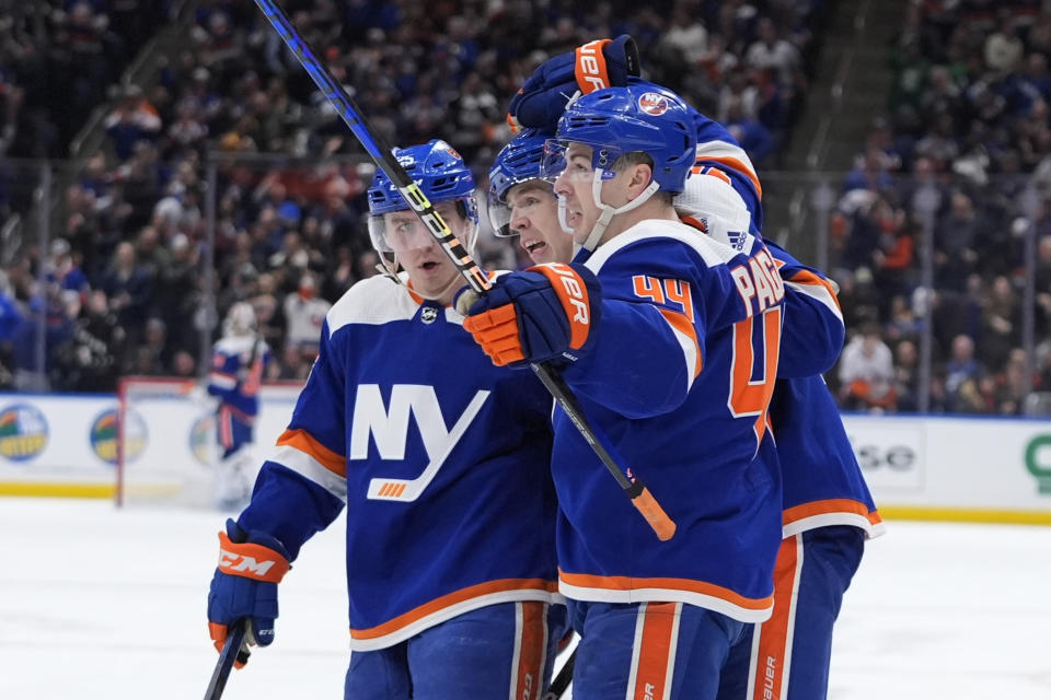 New York Islanders' Jean-Gabriel Pageau (44) celebrates with teammates after scoring against the St. Louis Blues during the second period of an NHL hockey game Tuesday, March 5, 2024, in Elmont, N.Y. (AP Photo/Frank Franklin II)