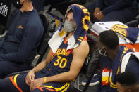 Golden State Warriors guard Stephen Curry (30) sits on the bench in the second half during an NBA basketball game against the Utah Jazz, Saturday, Jan. 23, 2021, in Salt Lake City. (AP Photo/Rick Bowmer)