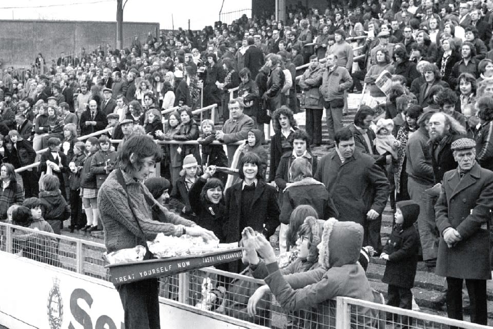 The terraces at The Den, New Cross, enjoying some old-school footy scran