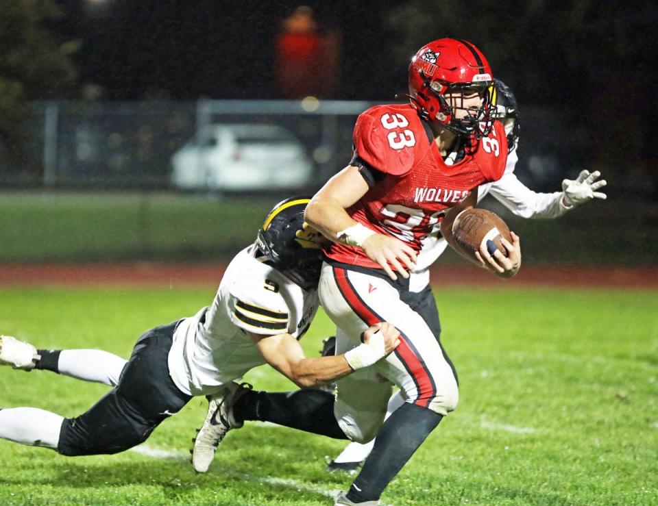 Cam Buffington (33) breaks free of a tackle and goes on to score one of three touchdowns for the Wolves.