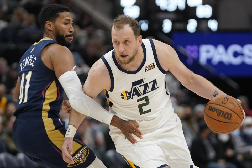 Utah Jazz guard Joe Ingles (2) drives around New Orleans Pelicans forward Garrett Temple (41) the second half of a preseason NBA basketball game Monday, Oct. 11, 2021, in Salt Lake City. (AP Photo/Rick Bowmer)